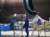 An employee works on a large pressure vessel customized by an oil refinery at the production workshop of Qingdao Lanshi Heavy Machinery Equi...