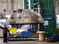 An employee works on a large pressure vessel customized by an oil refinery at the production workshop of Qingdao Lanshi Heavy Machinery Equi...