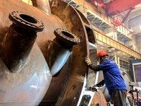 An employee works on a large pressure vessel customized by an oil refinery at the production workshop of Qingdao Lanshi Heavy Machinery Equi...