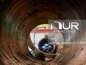 An employee works on a large pressure vessel customized by an oil refinery at the production workshop of Qingdao Lanshi Heavy Machinery Equi...