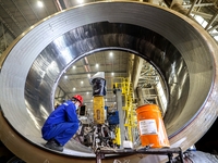 An employee works on a large pressure vessel customized by an oil refinery at the production workshop of Qingdao Lanshi Heavy Machinery Equi...