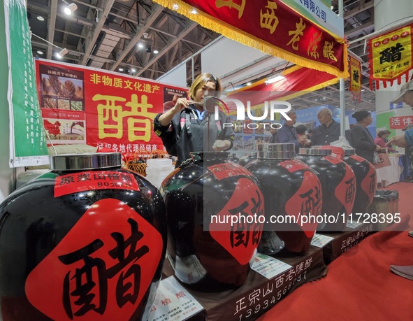 An exhibitor displays Shanxi aged vinegar at the 2024 Yantai International Food Industry Expo in Yantai, China, on November 1, 2024. 