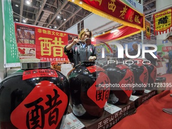 An exhibitor displays Shanxi aged vinegar at the 2024 Yantai International Food Industry Expo in Yantai, China, on November 1, 2024. (