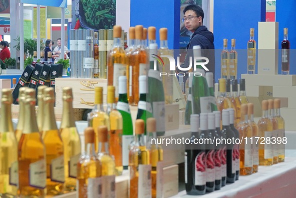 Visitors learn about wine products at the 2024 Yantai International Food Industry Expo in Yantai, China, on November 1, 2024. 