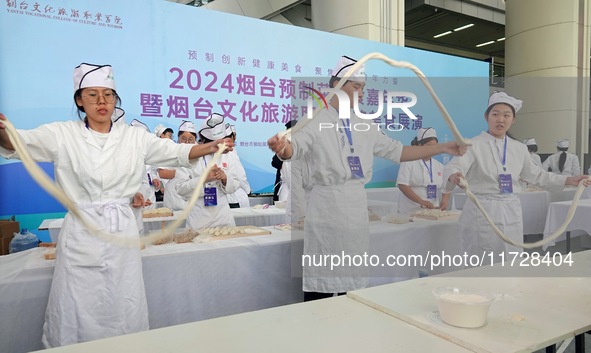 Students from Yantai Vocational College of Culture and Tourism perform during a cooking show at the 2024 Yantai International Food Industry...