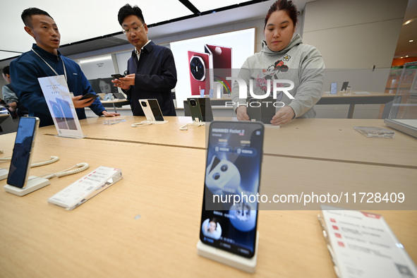 Customers shop for mobile phones at the Huawei store at Deji Square in Nanjing, China, on November 1, 2024. 