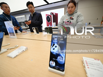 Customers shop for mobile phones at the Huawei store at Deji Square in Nanjing, China, on November 1, 2024. (