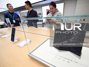 Customers shop for mobile phones at the Huawei store at Deji Square in Nanjing, China, on November 1, 2024. (