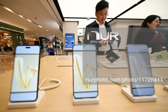 Customers shop for mobile phones at the Huawei store at Deji Square in Nanjing, China, on November 1, 2024. 