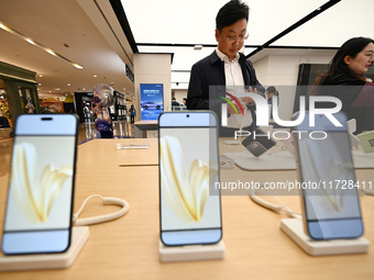 Customers shop for mobile phones at the Huawei store at Deji Square in Nanjing, China, on November 1, 2024. (