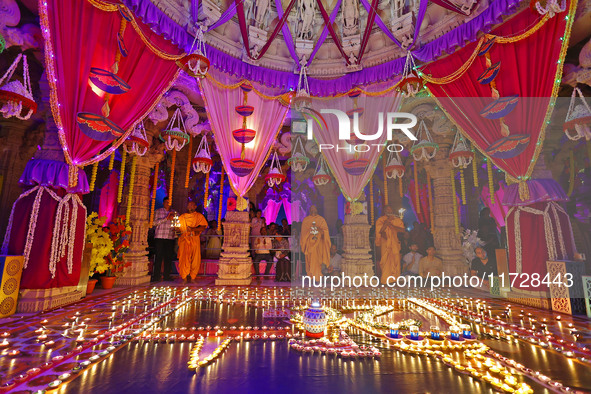 Priests perform 'aarti' at the Akshardham temple during the 'Deepotsav' celebration on the occasion of the 'Diwali' festival in Jaipur, Raja...