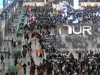 The waiting hall of Hongqiao Railway Station in Shanghai, China, on November 1, 2024, is crowded with passengers. Affected by Typhoon Kong-R...