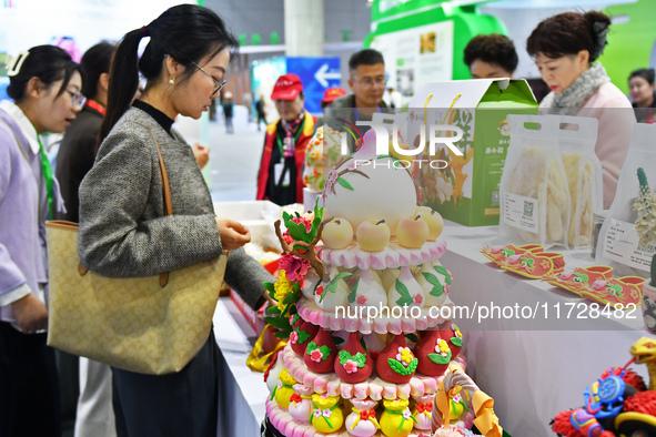 Visitors learn about Huamo products at the 2024 Yantai International Food (Prepared Dish) Industry Expo in Yantai, China, on November 1, 202...