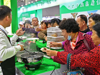 Visitors taste juice drinks at the 2024 Yantai International Food (Prepared Dish) Industry Expo in Yantai, China, on November 1, 2024. (