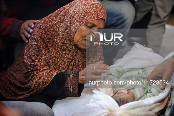 (EDITOR'S NOTE: Image depicts death) A Palestinian woman mourns her grandson, one of the victims of an Israeli bombing that targets a house...