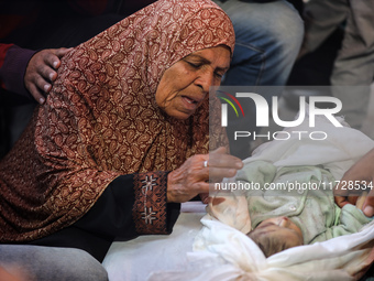 (EDITOR'S NOTE: Image depicts death) A Palestinian woman mourns her grandson, one of the victims of an Israeli bombing that targets a house...