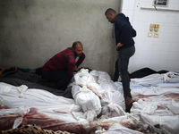 (EDITOR'S NOTE: Image depicts death) A Palestinian stands beside the bodies of victims from an Israeli airstrike that targets a house in the...