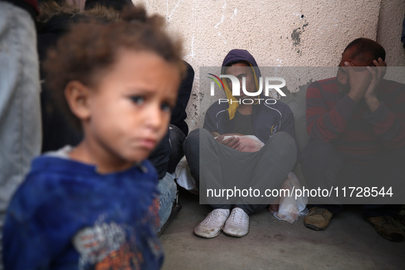 (EDITOR'S NOTE: Image depicts death) Palestinians surround the body of a victim from an Israeli airstrike that targets a house in the Nuseir...