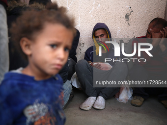 (EDITOR'S NOTE: Image depicts death) Palestinians surround the body of a victim from an Israeli airstrike that targets a house in the Nuseir...