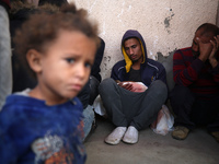 (EDITOR'S NOTE: Image depicts death) Palestinians surround the body of a victim from an Israeli airstrike that targets a house in the Nuseir...