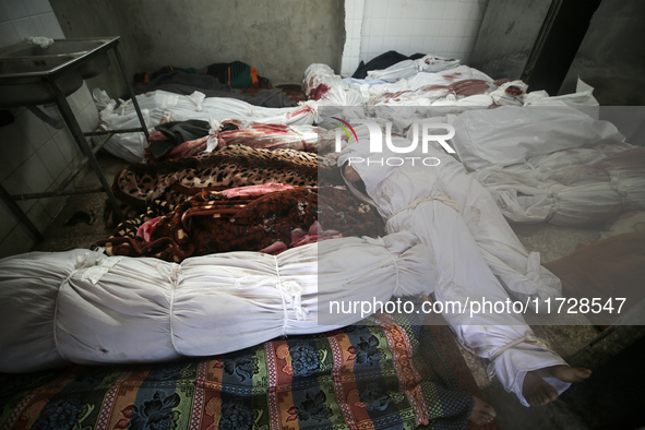 (EDITOR'S NOTE: Image depicts death) The bodies of victims from an Israeli airstrike that targets a house in the Nuseirat refugee camp in ce...