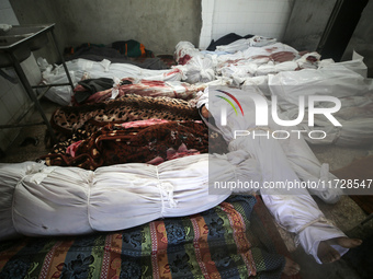 (EDITOR'S NOTE: Image depicts death) The bodies of victims from an Israeli airstrike that targets a house in the Nuseirat refugee camp in ce...