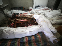 (EDITOR'S NOTE: Image depicts death) The bodies of victims from an Israeli airstrike that targets a house in the Nuseirat refugee camp in ce...