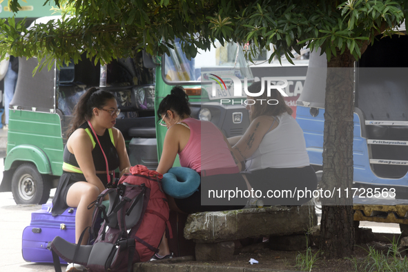 A group of tourists sits in front of Colombo railway station in Colombo, Sri Lanka, on November 1, 2024. The tourism sector shows remarkable...