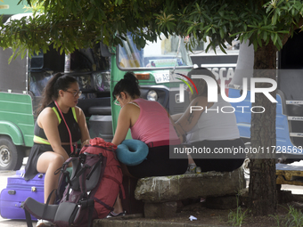 A group of tourists sits in front of Colombo railway station in Colombo, Sri Lanka, on November 1, 2024. The tourism sector shows remarkable...