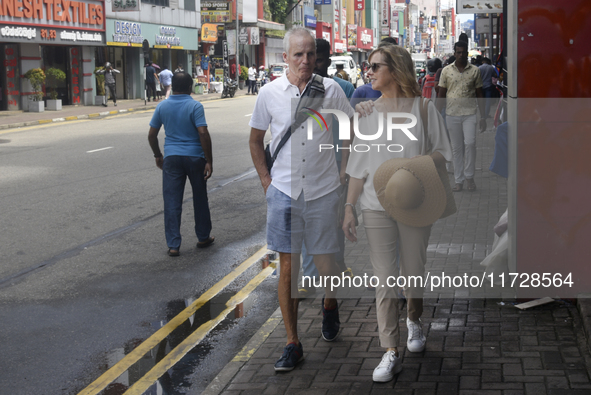 Tourists walk in Colombo Fort in Colombo, Sri Lanka, on November 1, 2024. The tourism sector shows remarkable financial recovery, with earni...