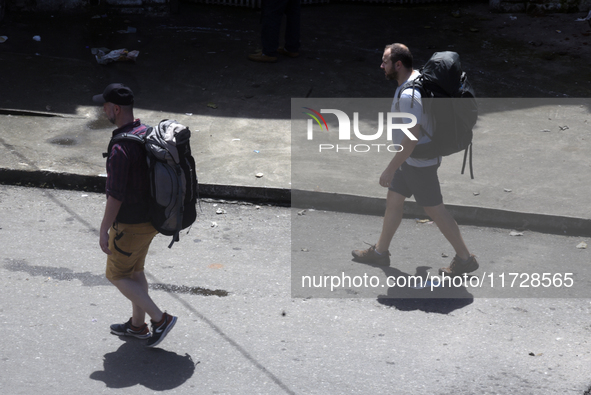 Tourists walk next to the Colombo railway station in Colombo, Sri Lanka, on November 1, 2024. The tourism sector shows remarkable financial...