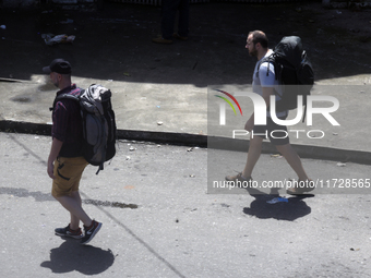 Tourists walk next to the Colombo railway station in Colombo, Sri Lanka, on November 1, 2024. The tourism sector shows remarkable financial...