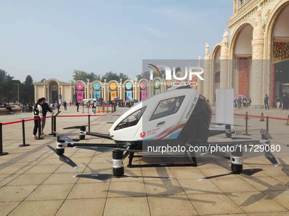 Visitors visit a manned unmanned electric vertical take-off and landing aircraft at the 2024 Beijing International Cultural and Tourism Cons...