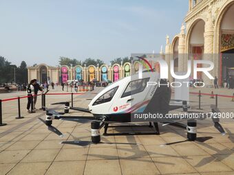 Visitors visit a manned unmanned electric vertical take-off and landing aircraft at the 2024 Beijing International Cultural and Tourism Cons...