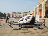 Visitors visit a manned unmanned electric vertical take-off and landing aircraft at the 2024 Beijing International Cultural and Tourism Cons...