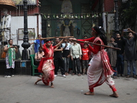 Girls wield bamboo sticks during an event to demonstrate self-defense skills as part of the celebration of the Hindu festival of Kali Puja o...