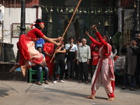 Girls wield bamboo sticks during an event to demonstrate self-defense skills as part of the celebration of the Hindu festival of Kali Puja o...