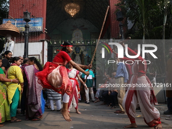 Girls wield bamboo sticks during an event to demonstrate self-defense skills as part of the celebration of the Hindu festival of Kali Puja o...