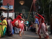 Girls wield bamboo sticks during an event to demonstrate self-defense skills as part of the celebration of the Hindu festival of Kali Puja o...