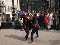 Girls wield knives during an event to demonstrate self-defense skills as part of the celebration of the Hindu festival of Kali Puja outside...