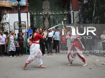 Girls wield swords during an event held to demonstrate self-defense skills as part of the celebration of the Hindu festival of Kali Puja out...