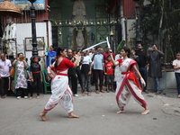 Girls wield swords during an event held to demonstrate self-defense skills as part of the celebration of the Hindu festival of Kali Puja out...