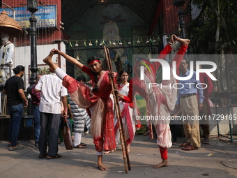 Girls wield knives during an event to demonstrate self-defense skills as part of the celebration of the Hindu festival of Kali Puja outside...