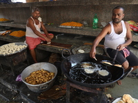 Workers prepare offerings before distributing them to devotees after worship as part of the celebration of the Hindu festival of Kali Puja o...