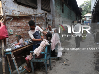 People get a shave from roadside barbers before they attend the Hindu festival of Kali Puja outside a ''pandal'' (a permanent platform), a d...