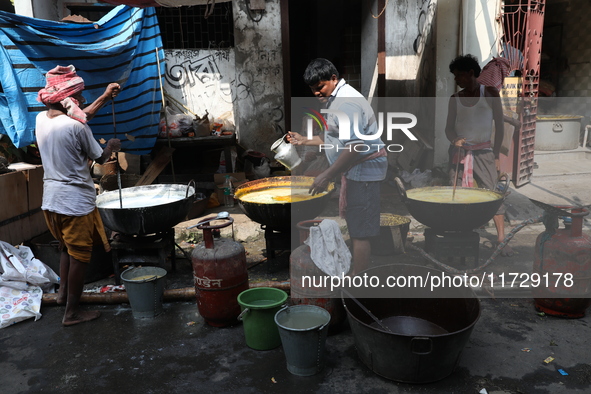 Workers prepare offerings before distributing them to devotees after worship as part of the celebration of the Hindu festival of Kali Puja o...