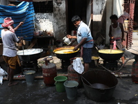 Workers prepare offerings before distributing them to devotees after worship as part of the celebration of the Hindu festival of Kali Puja o...