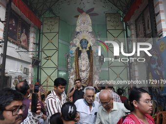 People visit a pandal, a decorated structure, during the celebration of the Hindu festival of Kali Puja in Kolkata, India, on November 1, 20...