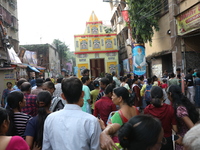 Devotees stand in a queue to have offerings after worshiping the Hindu goddess Kali outside a ''pandal'' (a temporary platform), a decorated...