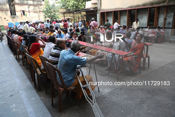 Devotees have offerings after worshiping the Hindu goddess Kali outside a ''pandal,'' a decorated temporary platform, on the occasion of the...